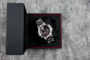 Bangkok, Thailand - February 3, 2024 Open box of Casio G-Shock model MTG-B1000D-1ADR, stainless steel wristwatch. photo