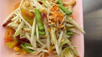 Papaya salad yummy or somtum is a spicy Thai food photo