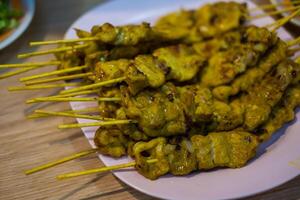 Grilled pork satay with skewer on dish photo