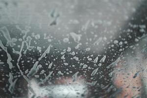 Soap suds on the glass. View from Inside car, automatic car wash. Background image and texture. photo