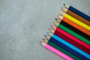 Brightly colored art pencils in a row photo