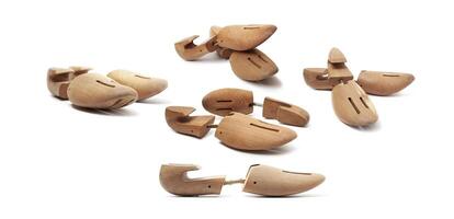 Group of wooden shoe pads and stretchers isolated on a white photo