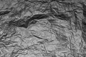 Crumpled craft black color paper texture photo