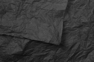 Crumpled craft black color paper texture photo