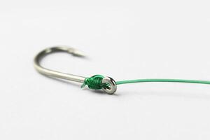 fishing hook with fishing line on white background. photo