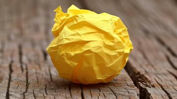 AI generated Crumpled Yellow Paper Ball on Wooden Surface photo