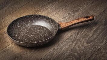 Modern frying pan with non-stick granite coating photo