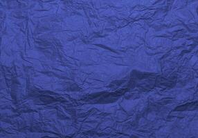 Crumpled craft blue color paper texture photo