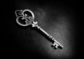 Old bronze key on a dark background photo