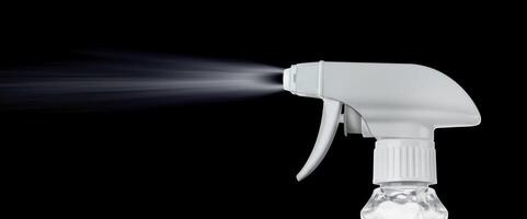 Close view of a plastic spray bottle's head for dispersion isolated on a black background photo