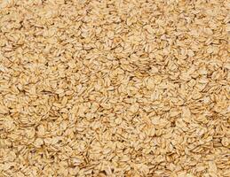 Surface coated with oatmeal flakes as a backdrop texture composi photo