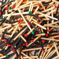 A lot of matches are mixed, of different color, isolated background photo