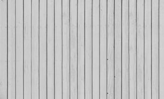 Wooden fence with parallel planks with white paint. photo