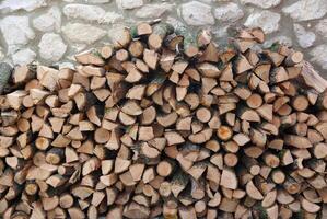 Firewood in a stone wall. Backgrounds and textures photo