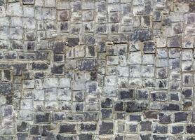 Natural stonewall, old stones in different sizes photo