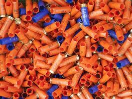 Background of many colorful shot empty shotgun shells photo