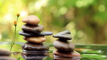 Water drops falling down with Balanced rocks pyramid on water with Golden light natural peace concepts bokeh on background video