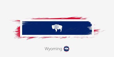 Flag of Wyoming US State, grunge abstract brush stroke on gray background. vector