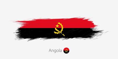 Flag of Angola, grunge abstract brush stroke on gray background. vector