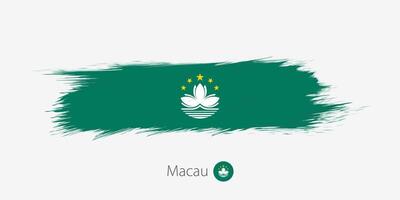 Flag of Macau, grunge abstract brush stroke on gray background. vector