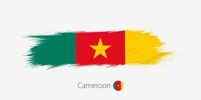 Flag of Cameroon, grunge abstract brush stroke on gray background. vector