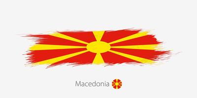 Flag of Macedonia, grunge abstract brush stroke on gray background. vector