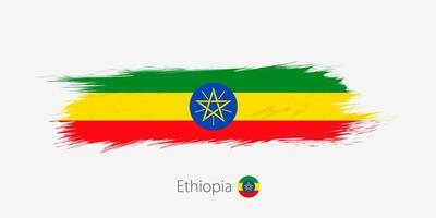 Flag of Ethiopia, grunge abstract brush stroke on gray background. vector