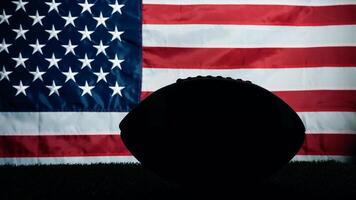 Silhouette of American football ball against usa flag photo