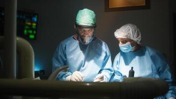 Doctor and assistant works in operating room photo