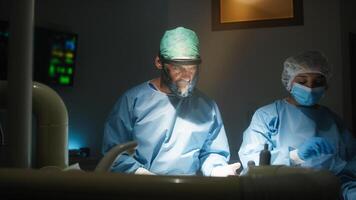 Doctor and assistant works in operating room photo