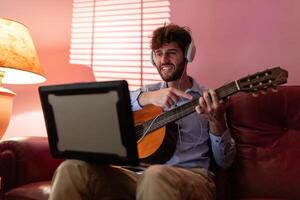 Boy Learning Remote Music Guitar Lesson By Computer Streaming Call photo