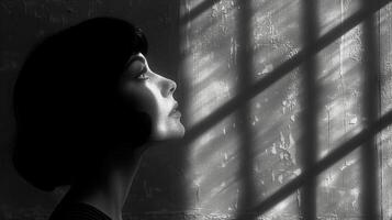 AI generated Contemplative woman by window with light and shadows in monochrome photo