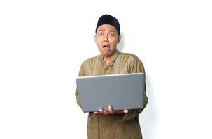 shocked asian muslim man holding laptop looks scared isolated on white background photo