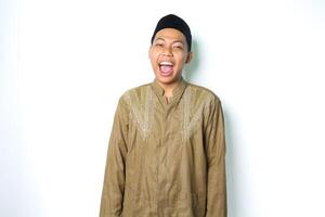 excited asian muslim man wearing islamic dress screaming at camera isolated in white background photo