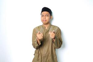 confused asian muslim man pointing at camera wearing koko clothes isolated on white background photo