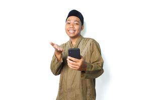 excited asian muslim man presenting application using mobile phone isolated on white background photo