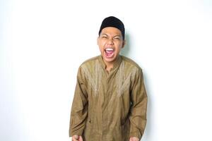 angry asian muslim male screaming with grabbing hand looking at camera isolated on white background photo