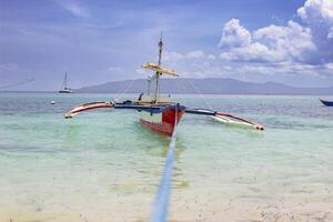 Boat stranded on a paradise beach photo