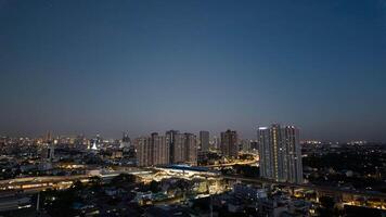 night city scape skyscraper architecture building modern sky urban light travel business downtown outdoor skyline street tower illuminated view background blue road panorama office traffic technology photo