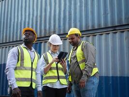 Group teamwork female male man woman person people human white yellow hardhat safety look see watch report tablet smartphone mobile order work job import export container copy space education study photo