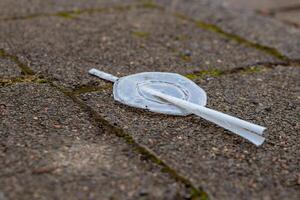 plastic waste on a footpath photo