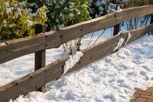 footpath with a small wooden fence in winter photo