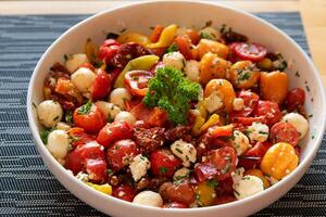 tomato and cheese salad in a bowl photo