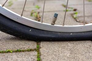 flat bicycle tire in selective focus photo