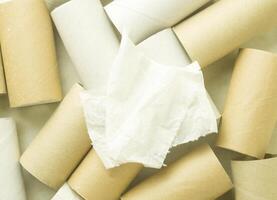 Two pieces of toilet paper on background of toilet paper empty rolls photo