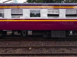 The side view of the bogie third class carriage of the ordinary train. photo