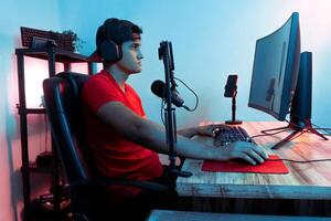 Gamer man playing a game in a computer. photo