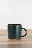 A dark blue ceramic mug photo