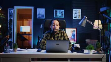 Man checking up on abroad living friend during video conference meeting over the internet. Caucasian person enjoying time together with mate in online video call session while at home, camera B