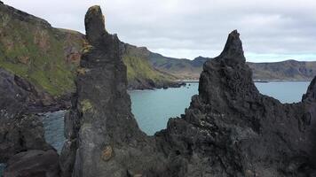 Rocks stick out of the water. Rocks in the water. Ocean and rocks. The nature of Iceland. Rocks. video